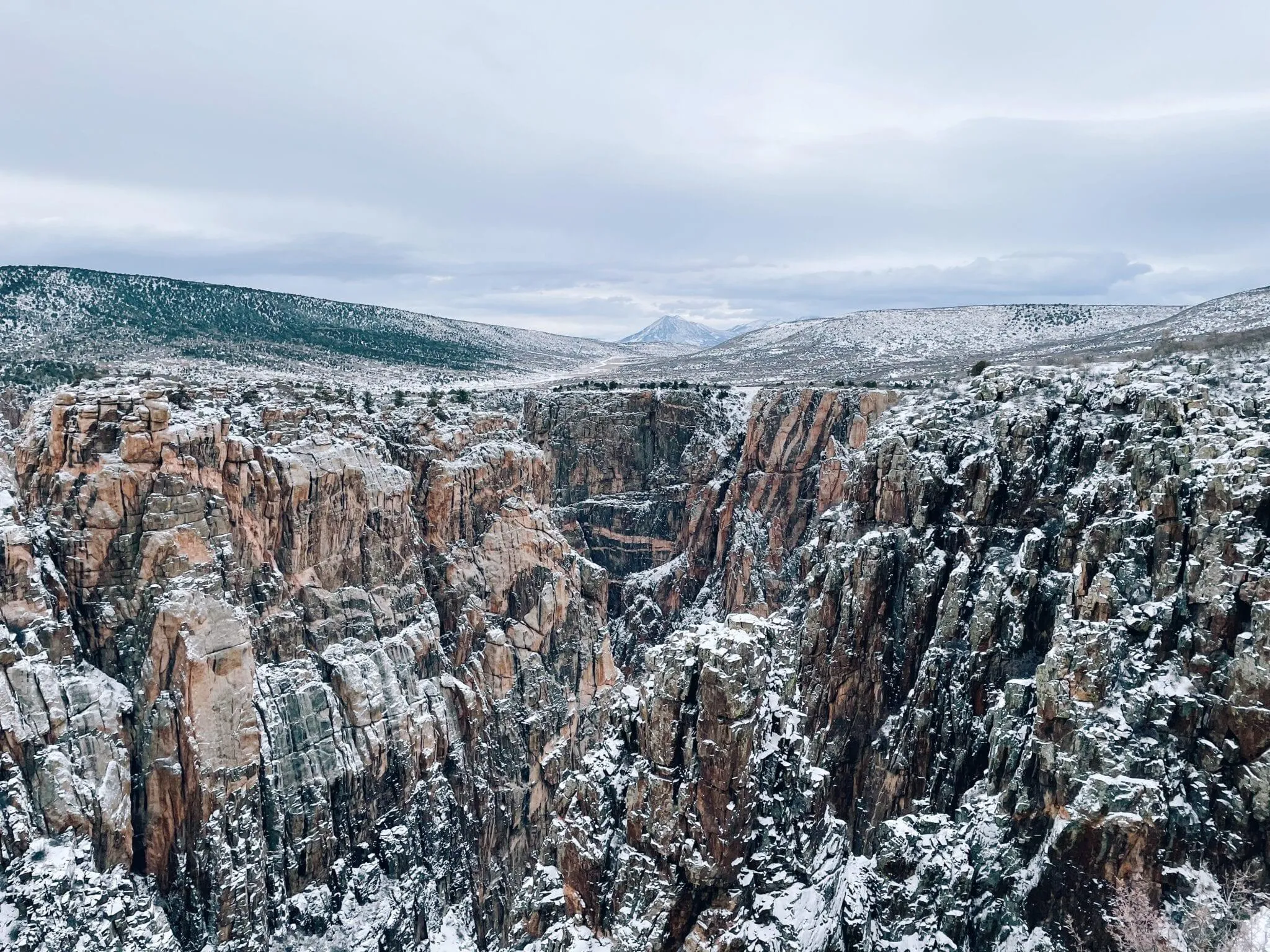Winter scene at Black Canyon of the Gunnison showing snow-covered rim and dramatic canyon views